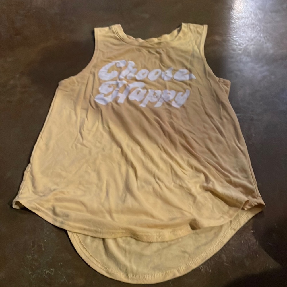 Yellow tank top, says “choose happy”